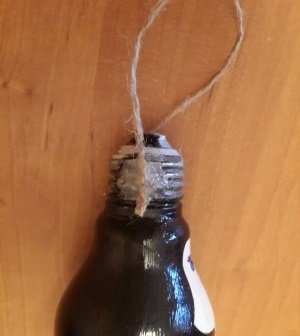 attach the loop penguin on the light bulb